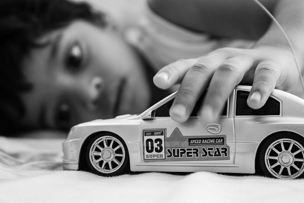 kid playing with a car